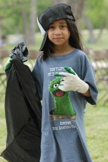 Young girl holding a trash bag