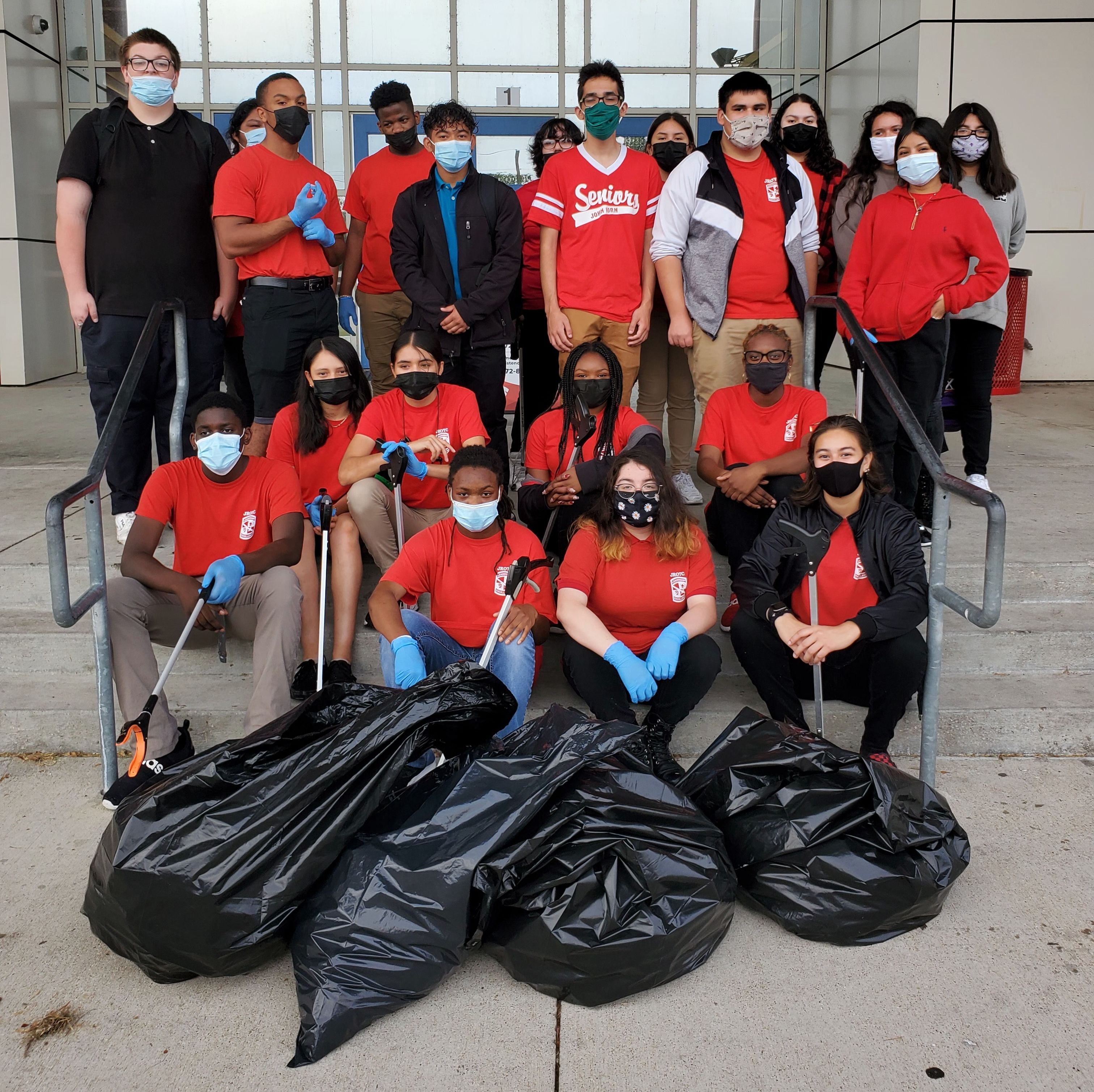 Photo of young people picking up bags of litter