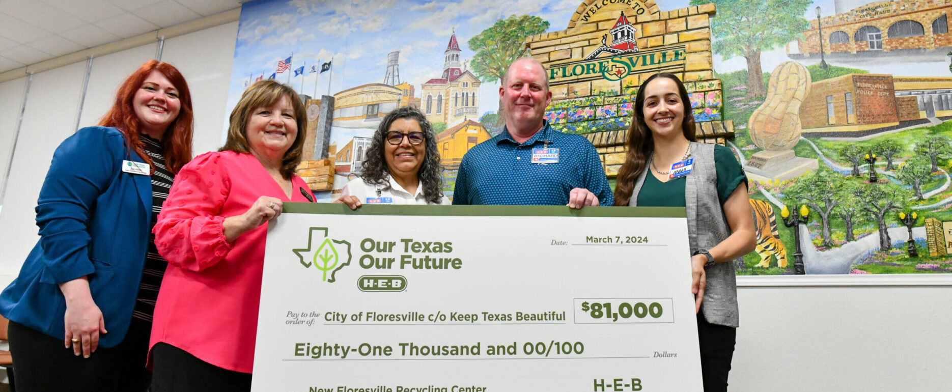 representatives from KTB, the city of Floresville, and H-E-B pose with a presentation check celebrating the grant awards to the city of Floresville to open a new recycling center